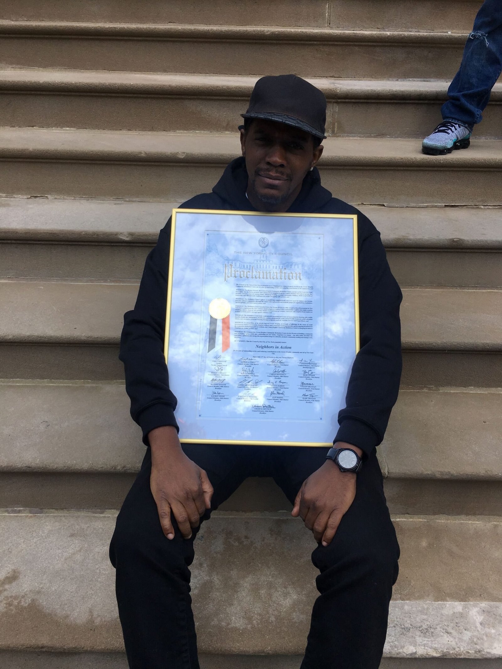 David Grant holding a New York City proclamation recognizing community leadership and anti-violence work.