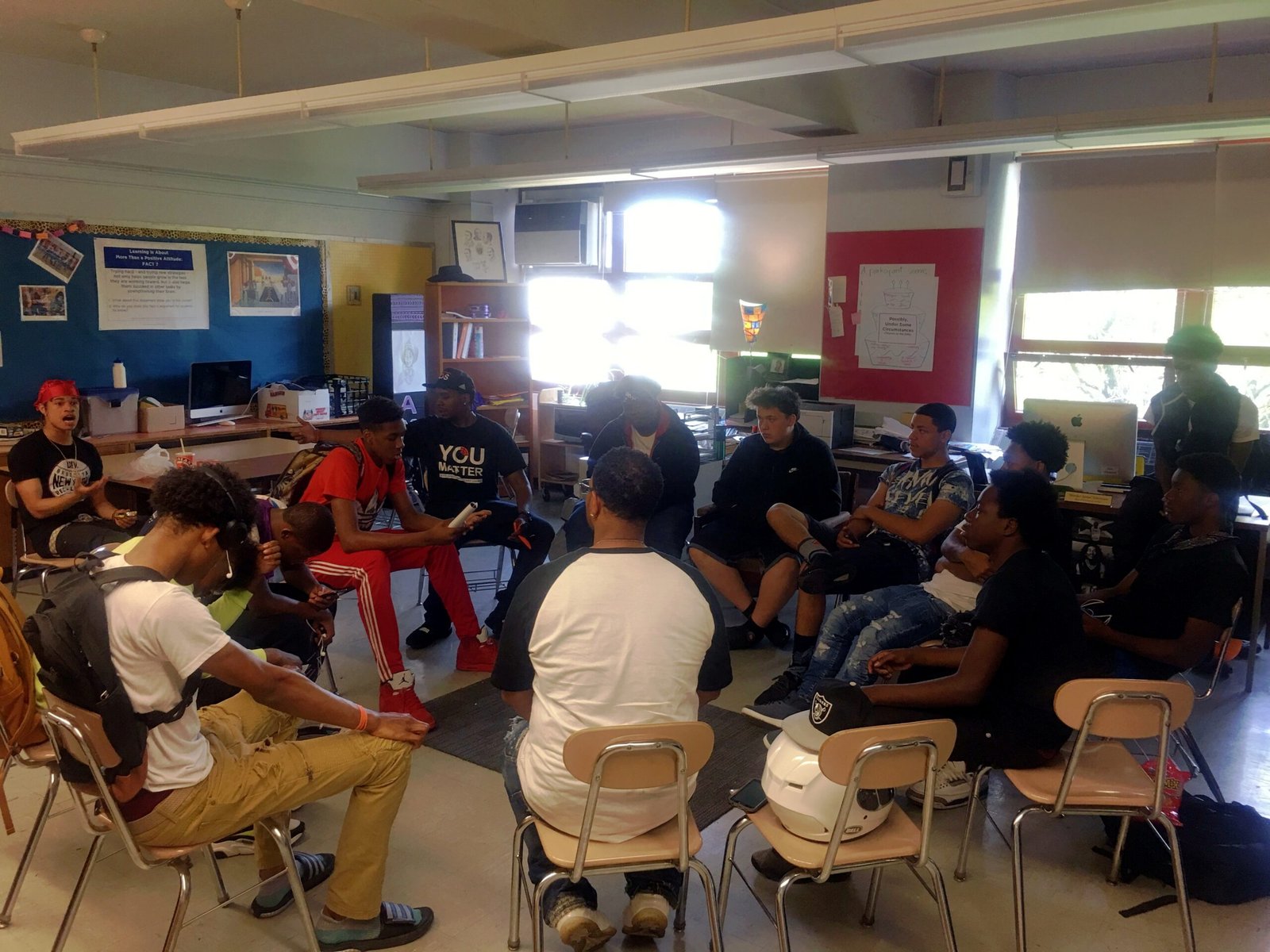 Chat & Smoke classroom session with youth seated in a healing circle