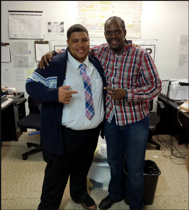 David Grant standing with a former youth participant after a successful job interview, representing mentorship, transformation, and community empowerment through Chat & Smoke